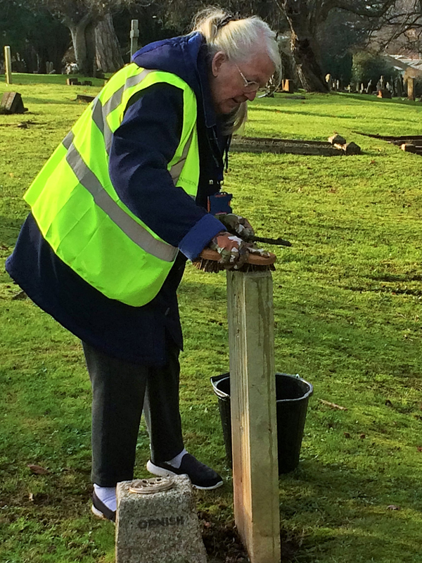 Vane Hill ARBD care home resident cleaning war graves as part of a new 'Eyes On, Hands-On' project run by The CWGC