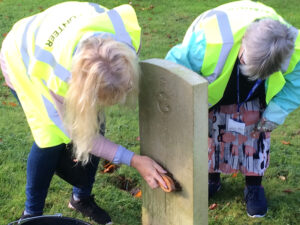 Vane Hill ARBD care home residents cleaning war graves as part of a new 'Eyes On, Hands-On' project run by The CWGC