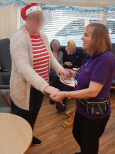 Campania ARBD care home staff and resident dancing