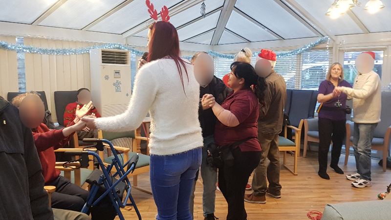 Campania ARBD care home staff and residents dancing during their Christmas Mini concert