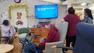 Campania ARBD care home residents singing Karaoke as part of their Christmas celebrations