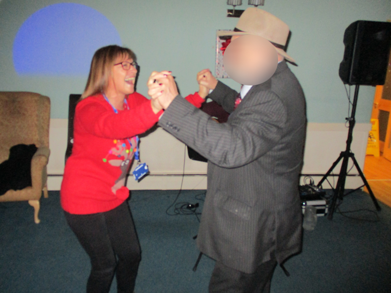 Serenita ARBD Care home staff and resident dancing at Christmas party