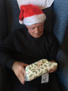 Vane Hill ARBD resident opening his present on Christmas Day