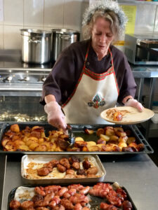Vane Hill ARBD care home resident dishing out the Christmas Day Lunch