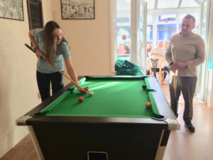 Cavan institute, Ireland, Nursing student playing pool with the resident at Vane Hill ARBD care home